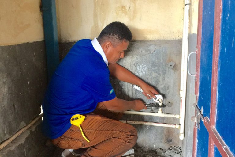 Keshav Gurung werkt aan een leiding Keshav Gurung werkt aan een leiding